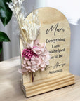 Freestanding wooden arch Mother’s Day plaque with floral arrangement