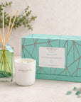 A reed diffuser and scented candle set from Brandle Bay Co in the Amazonite scent, displayed with their mint green geometric packaging box on a light stone surface.