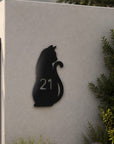 house number sign with black cat