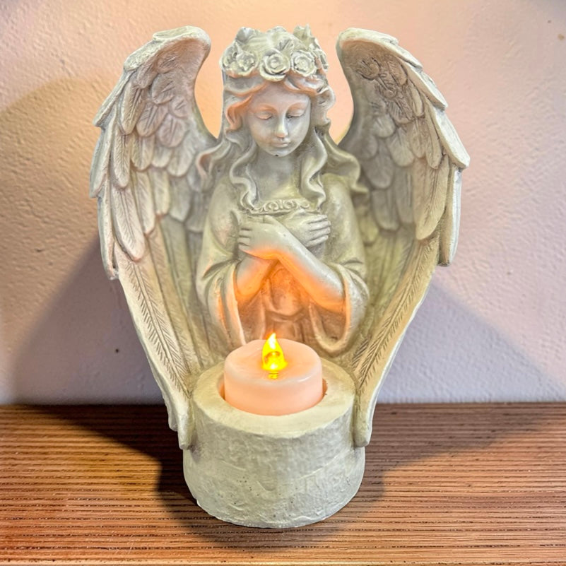 Statue of an angel with outstretched wings with LED candle 
