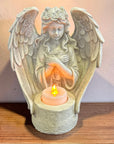 Statue of an angel with outstretched wings with LED candle 