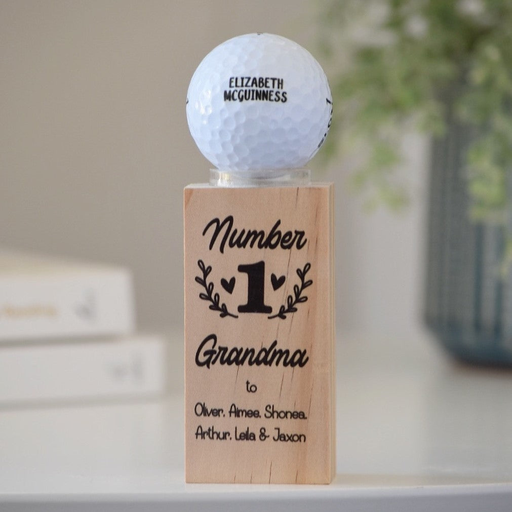 Personalised golf ball displayed on printed wooden stand with Mother’s Day message
