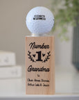 Personalised golf ball displayed on printed wooden stand with Mother’s Day message