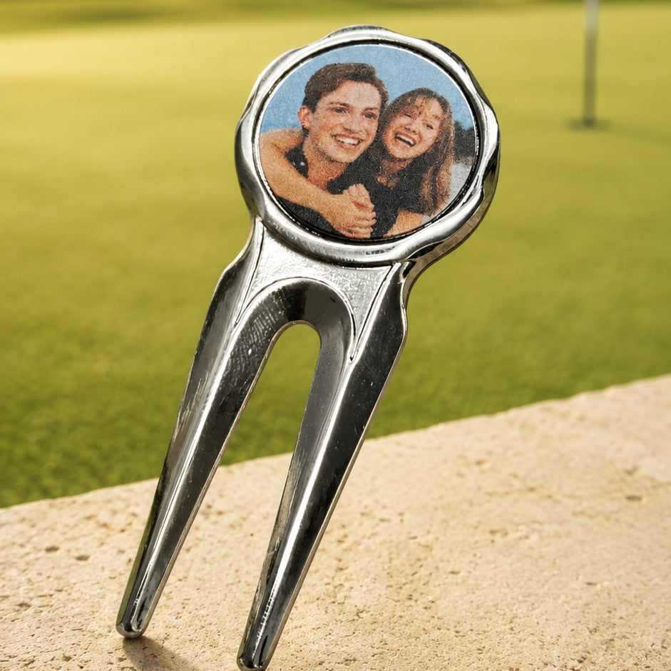 Golf divot tool with a photo