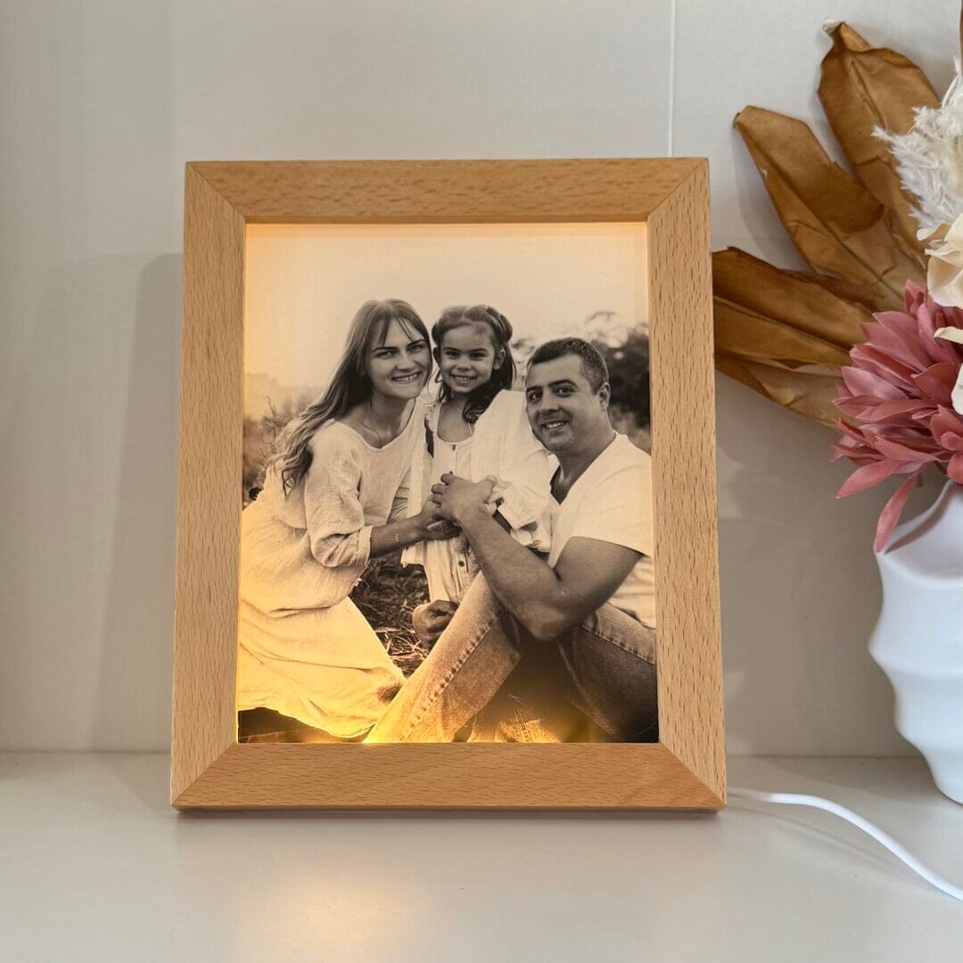 Custom LED photo frame printed on clear acrylic with warm glow